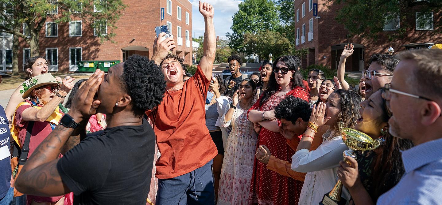 Students cheer the winners of the 2024 Homecoming Parade